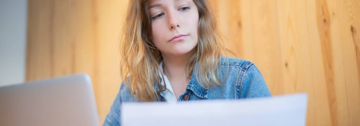 A Woman in Denim Jacket Looking at a Document